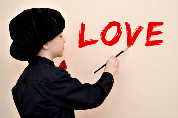 istock Young painter with the brush writing LOVE on the wall 939501930