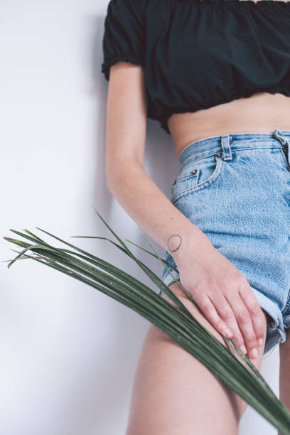 istock Young caucasian woman posing with plant 939505982