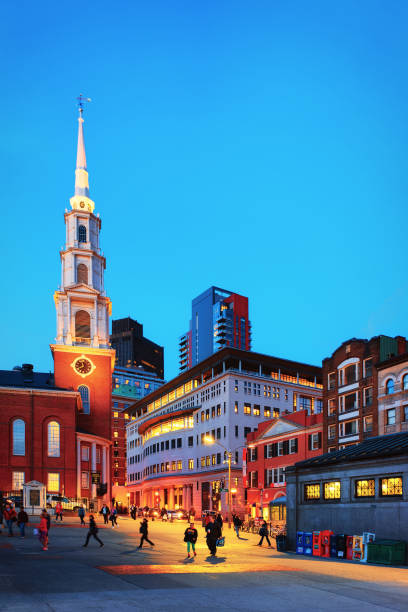 Boston, USA - April 29, 2015: Boston Common public park, downtown Boston, Massachusetts, the United States. Park Street Church and People on the background. Late in the evening