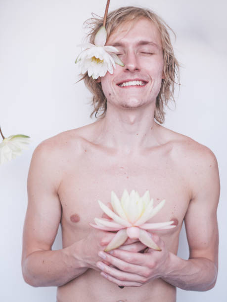 Young man holding lily stock photo