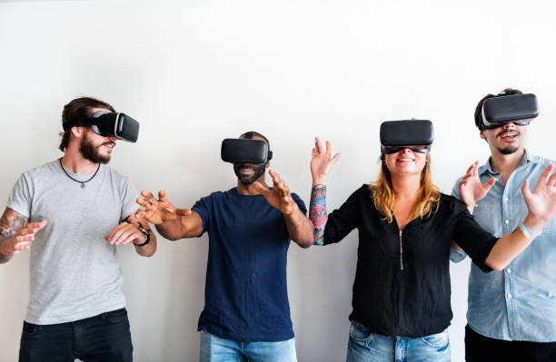 istock Group of diverse friends experiencing virtual reality with VR headset 939510088