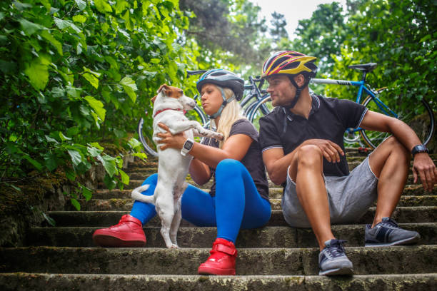 istock Couple posing with ther dog after bycicle riding. 939510370