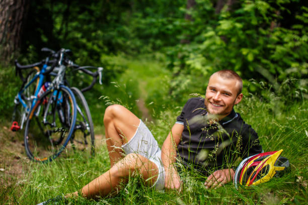 istock Positive male resting on a grass. 939512786