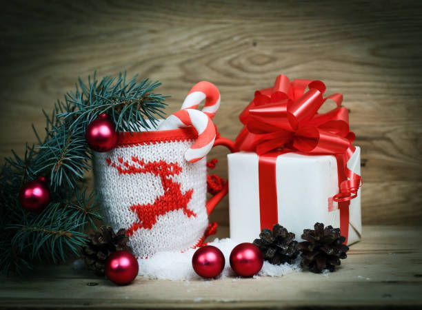 istock white box with Christmas present and Christmas Cup on a wooden 939513196