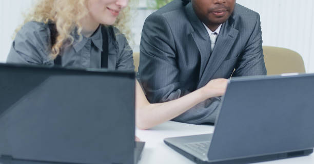 istock younger employees discussing business issues in office 939513222
