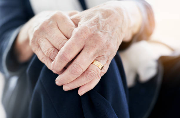 istock Senior woman's clasped, wrinkled hands 939514684
