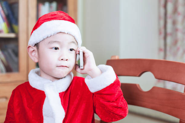 istock Young boy calling in Christmas celebration 939515582