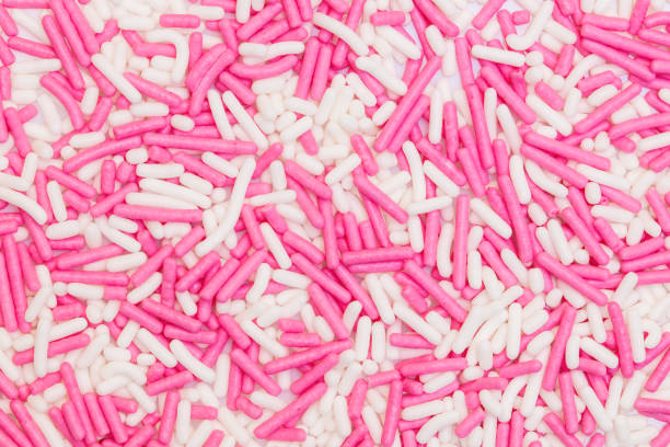 white and pink sugar sprinkles background, concept decoration and toppings