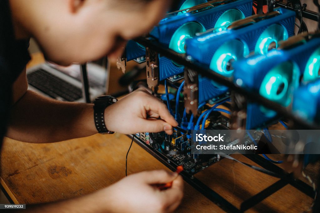 Man mining for bitcoin Cryptocurrency Mining Stock Photo