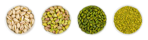 Pistachios in white porcelain bowls over white