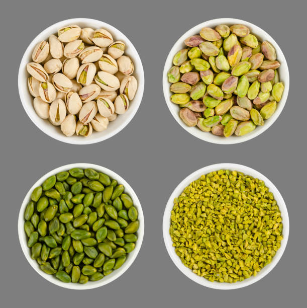 istock Pistachios in white porcelain bowls over gray 939538100