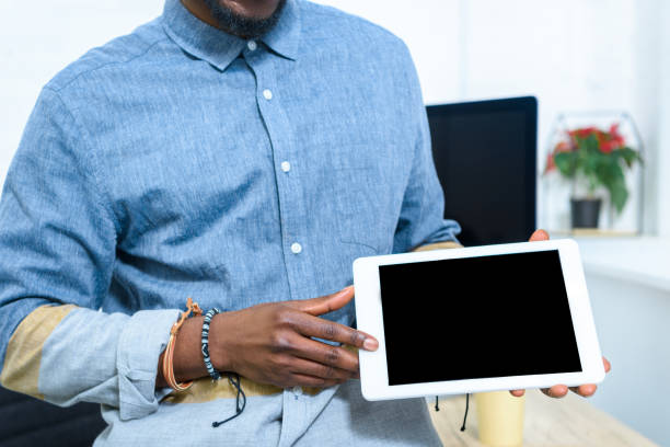 istock African american man showing digital tablet screen 939539088