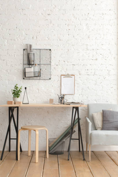 istock Desk with stationery in the white interior Loft 939542922