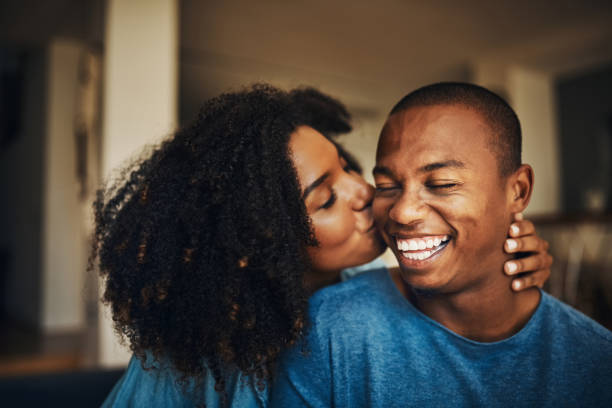 You're simply the best, babe Shot of an affectionate young couple relaxing at home cheek stock pictures, royalty-free photos & images