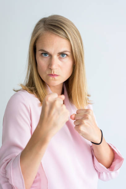 istock Determined young businesswoman in boxing stance 939549794