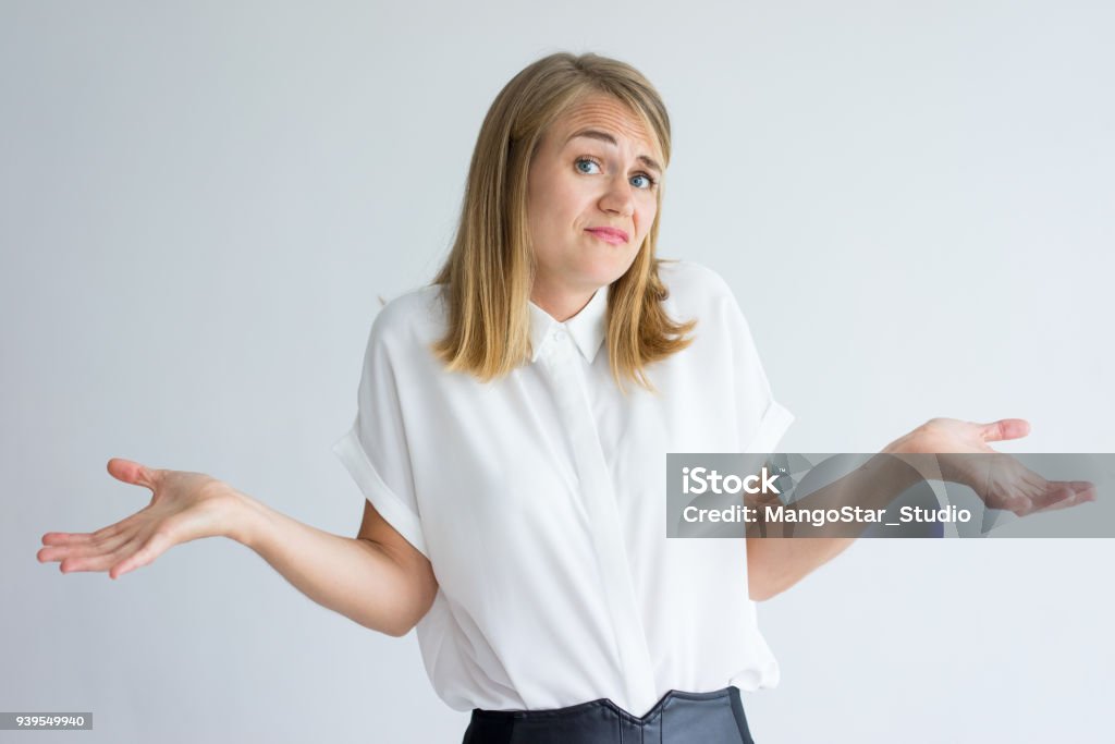 Verwirrt Studentin, die Schultern zuckt - Lizenzfrei Verwirrung Stock-Foto