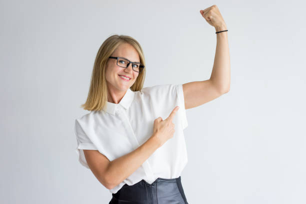 istock Smiling businesswoman or student showing muscles 939550164