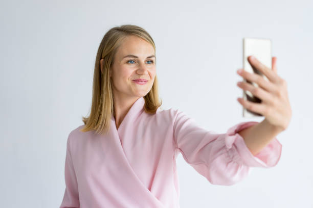 istock Smiling attractive woman taking selfie on phone 939553328