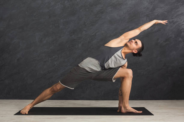 istock Man stretching hands and legs at gym 939561994