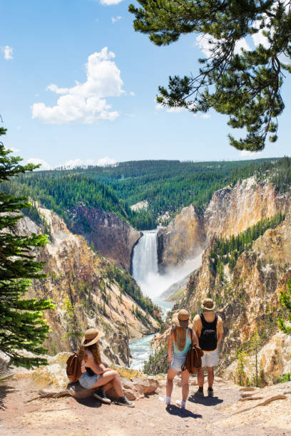 family relaxing and enjoying beautiful view of waterfall on hiking trip in the mountains. - yellowstone national park wyoming american culture landscape imagens e fotografias de stock