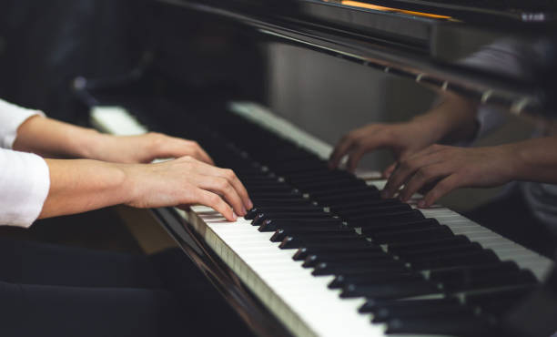 istock Female pianist playing on the piano 939566314