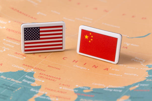 istock American flag and Chinese flag over world map 939567996