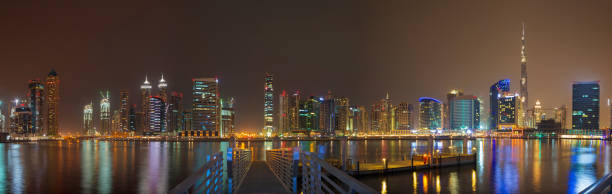 istock Dubai - The evening skyline over the Canal and Downtown. 939570404