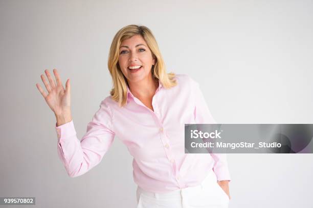 Smiling Pretty Woman Waving With Hand Stock Photo - Download Image Now - Waving - Gesture, Women, Greeting
