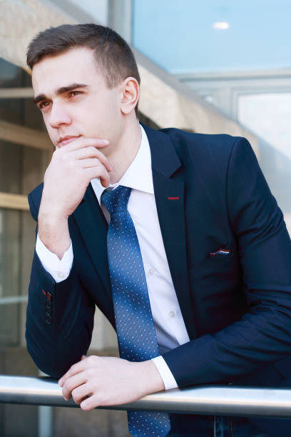 istock close up.young businessman standing on balcony in office 939571078