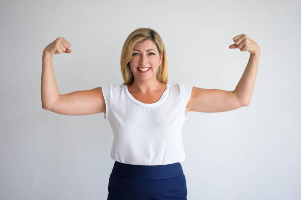 Happy Mature Caucasian Woman Flexing Biceps