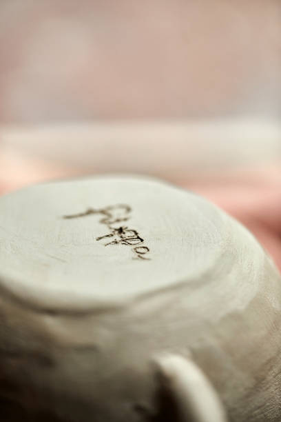 istock Close-up of text engraved on base of clay cup 939571952