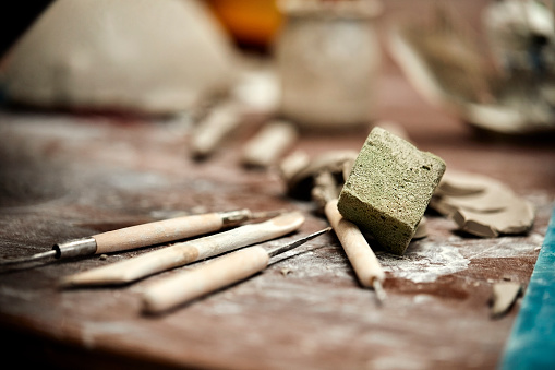 Scraping tools and sponge in pottery workshop