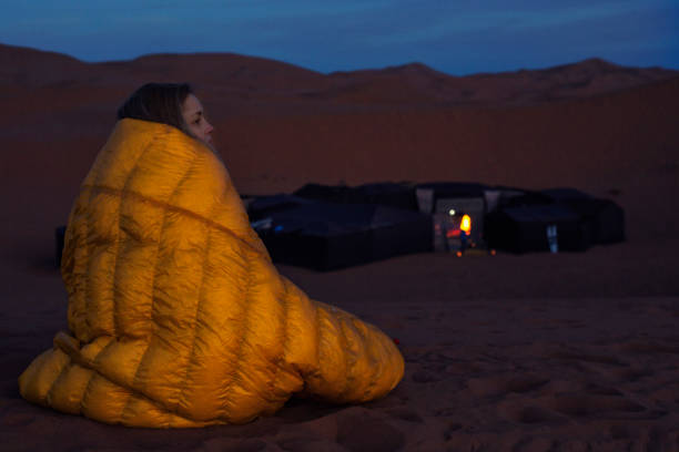 istock Admiring desert sunset. Cold evening. Camping in background. 939576900
