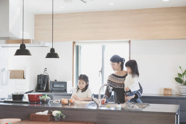 istock Mother and daughters cooking in the kitchen 939578688