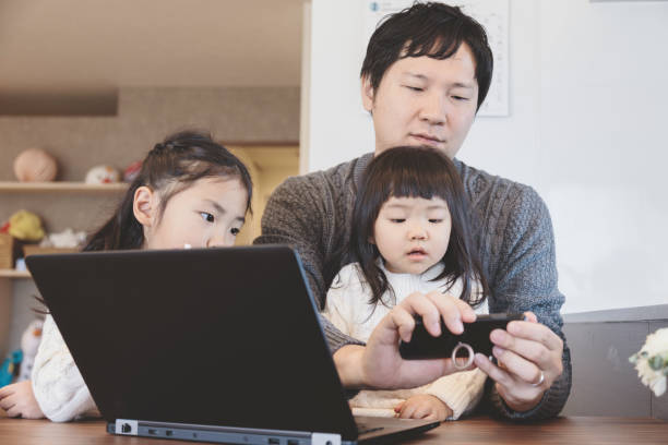 istock Father and daughters at home 939578874