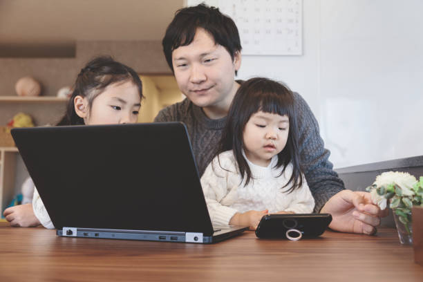istock Father and daughters at home 939578886