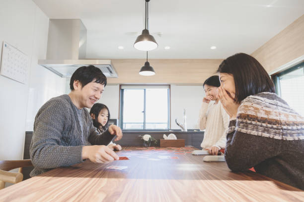 istock Family playing cards at home 939579494