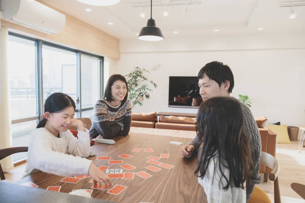 istock Family playing cards at home 939579508