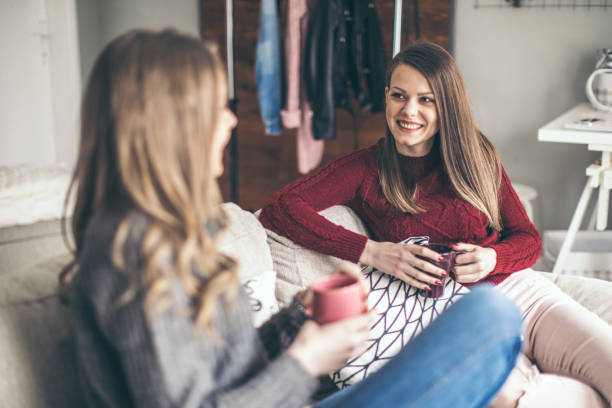 istock Two college girls relaxing 939580302