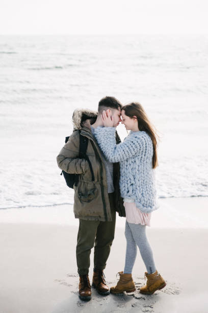 istock tender couple hugging on winter sea shore 939584096