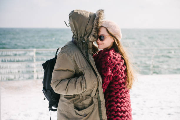 istock young couple hugging on quay at winter 939584292