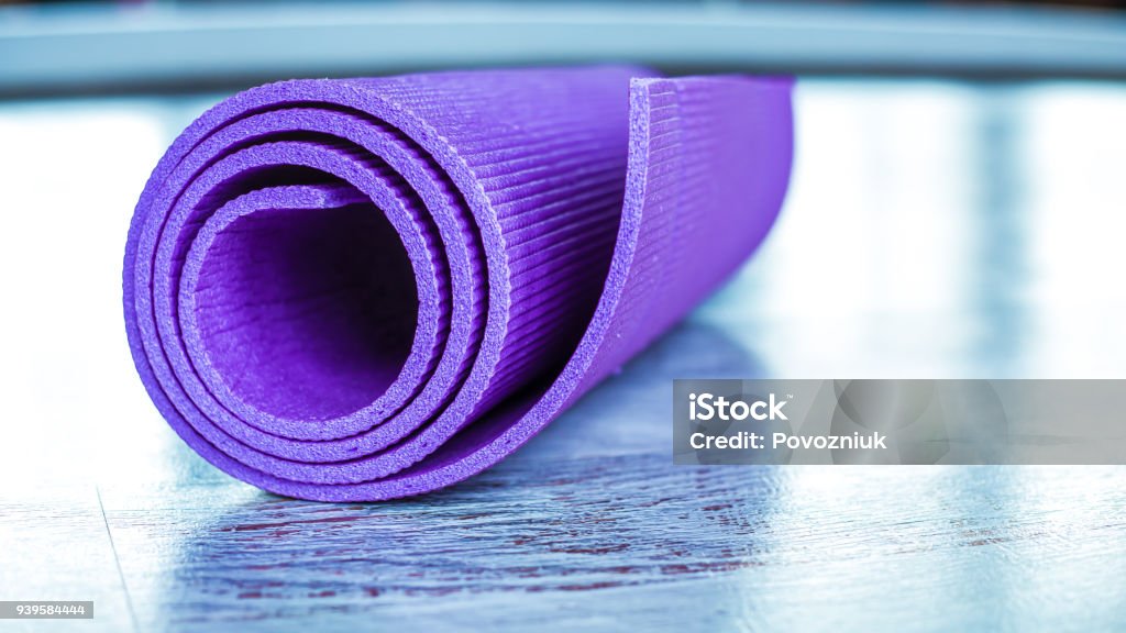 Mat for sports and yoga on the floor in the gym. Learning Stock Photo