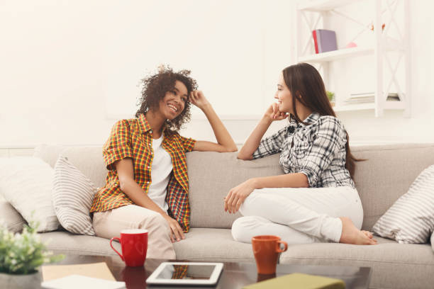 istock Two young female friends with coffee conversing 939585634