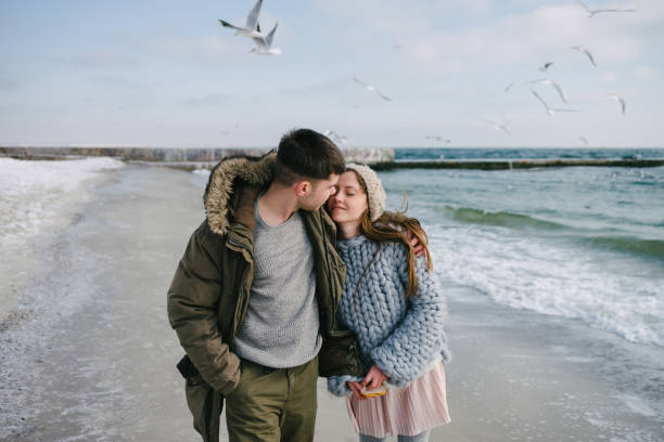 istock young tender couple hugging on winter sea shore 939586048