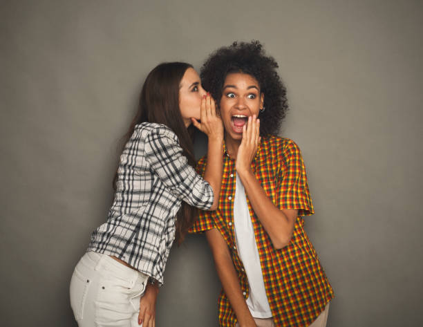 istock Young woman telling her friend some secrets 939586260