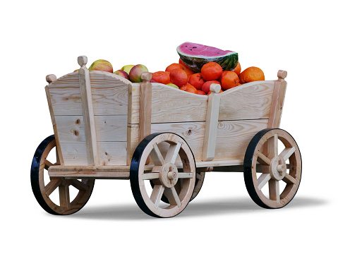 Retro style wooden fruit cart full with fruits,isolated on white background with a drop shadow.