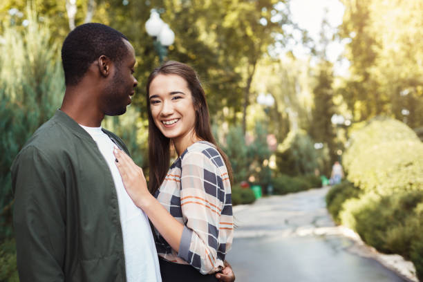istock Happy couple hugging in park copy space 939590504
