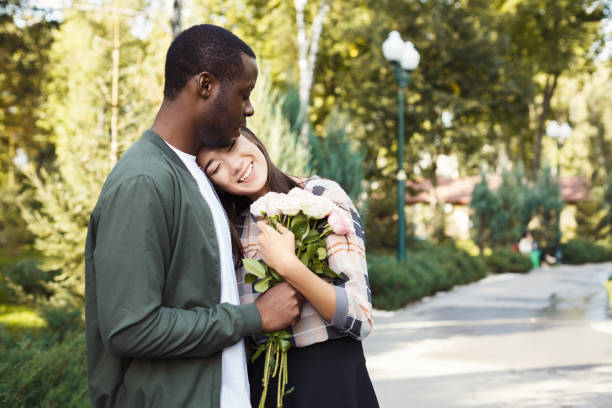 istock Man giving flowers for his beautiful girlfriend 939590622