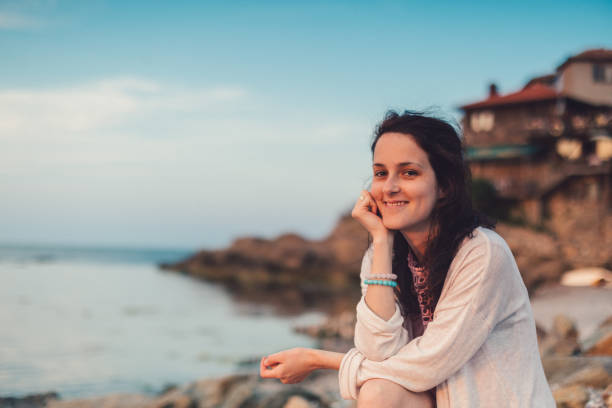 istock Smiling woman on seaside vacation 939590626