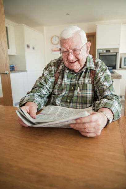 istock Senior Man Reading His Newspaper in the Morning 939597130